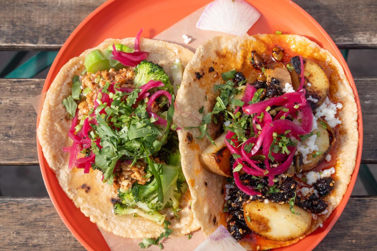 OAKLAND, CA - MAY 15: Charred broccoli taco, left, and taco de camote at Tacos Oscar in Oakland, CA on Thursday, May 15, 2025. (Myung J. Chun / Los Angeles Times).