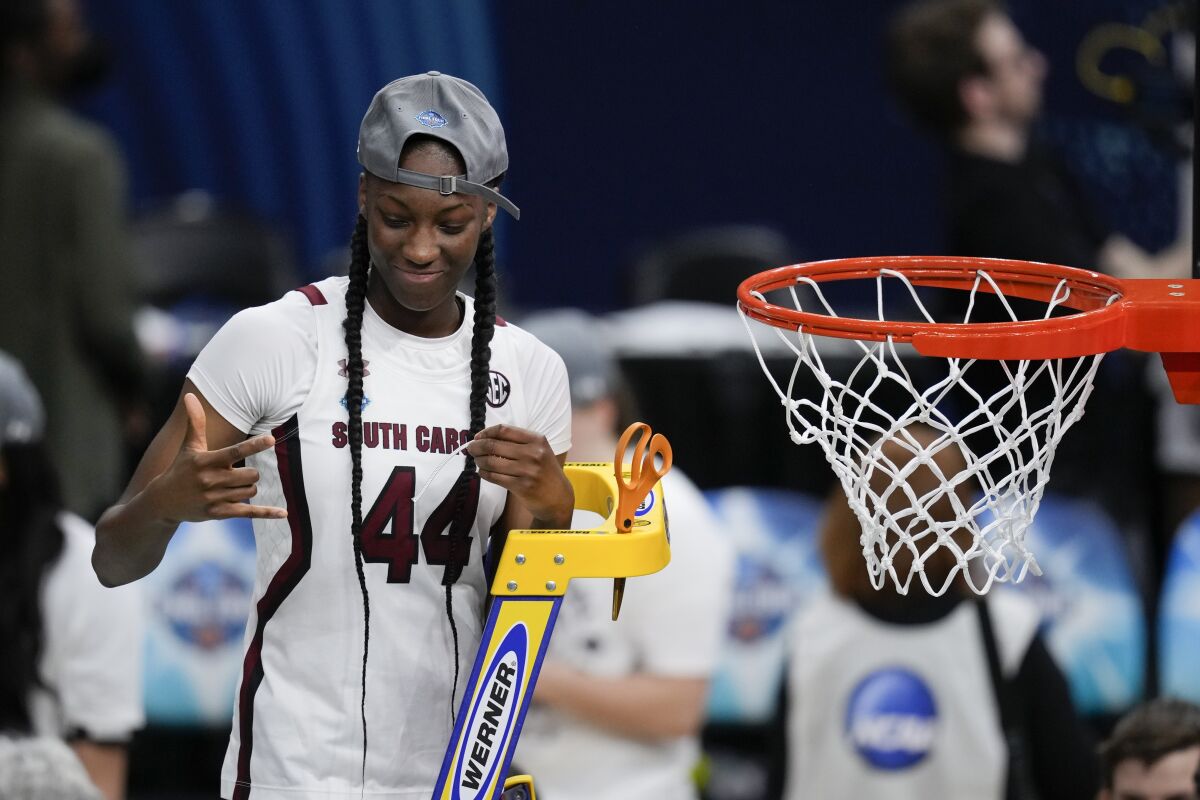 South Carolina's Saniya Rivers cuts the net after a college basketball game in the final round of the Women's Final Four NCAA tournament against UConn Sunday, April 3, 2022, in Minneapolis. South Carolina won 64-49 to win the championship. (AP Photo/Charlie Neibergall)