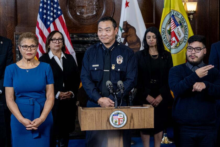 LOS ANGELES, CA - FEBRUARY 7, 2024: Dominic H. Choi has been named new LAPD interim chief at City Hall on February 7, 2024 in Los Angeles, California. Mayor Karen Bass is on the left.(Gina Ferazzi / Los Angeles Times)