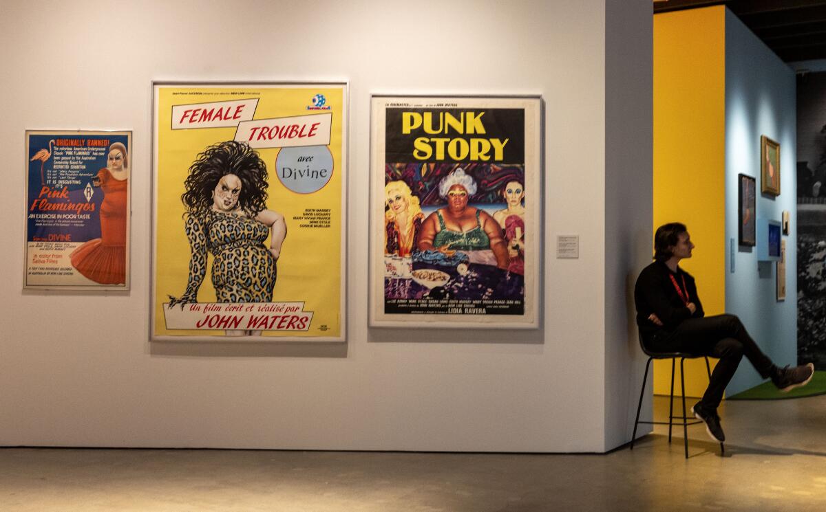 Posters line a gallery's wall.
