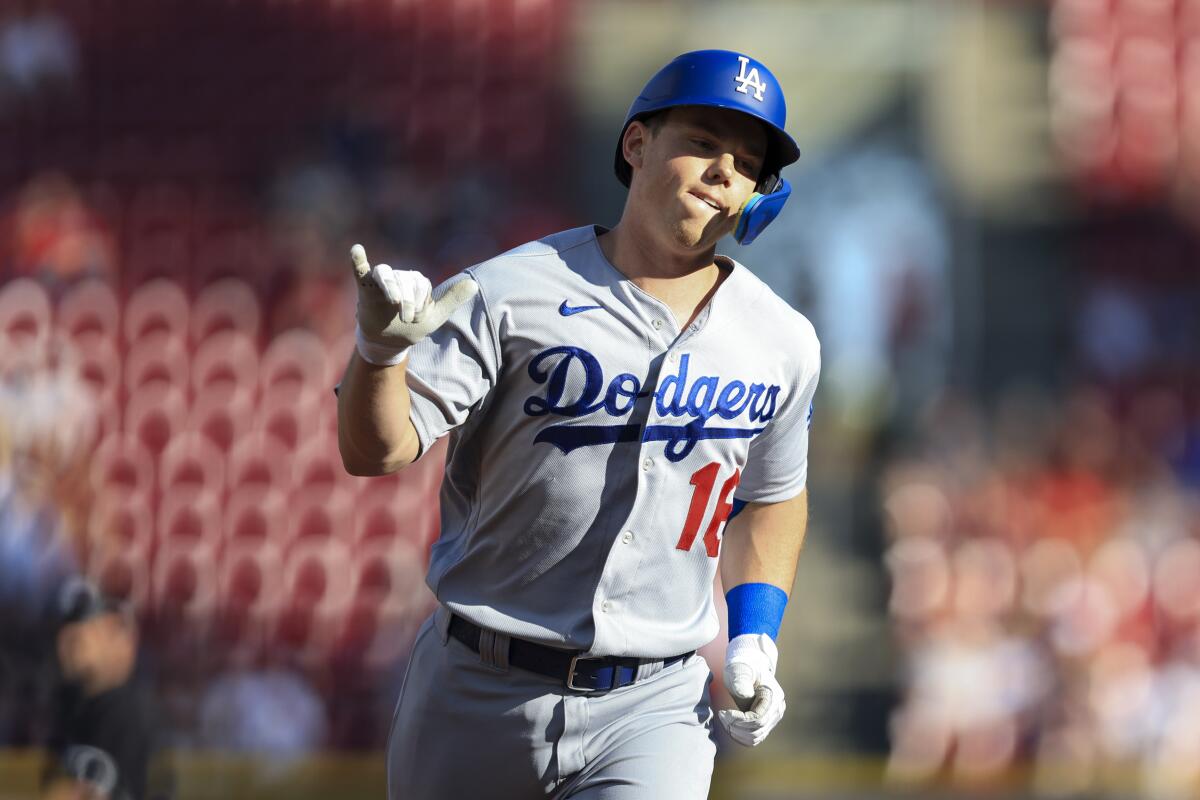 Dodgers catcher Will Smith gestures as he runs the bases after hitting a solo home run.