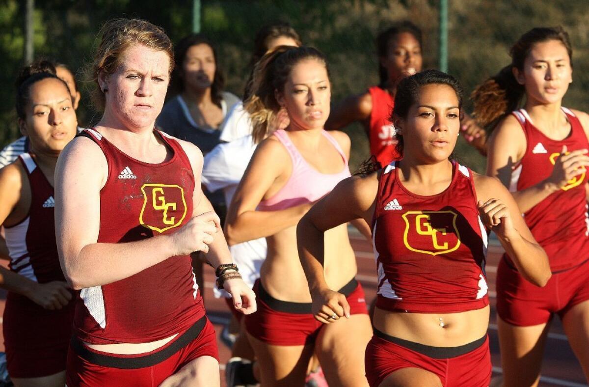 The Glendale Community College's women's cross country team works out during a practice on campus.