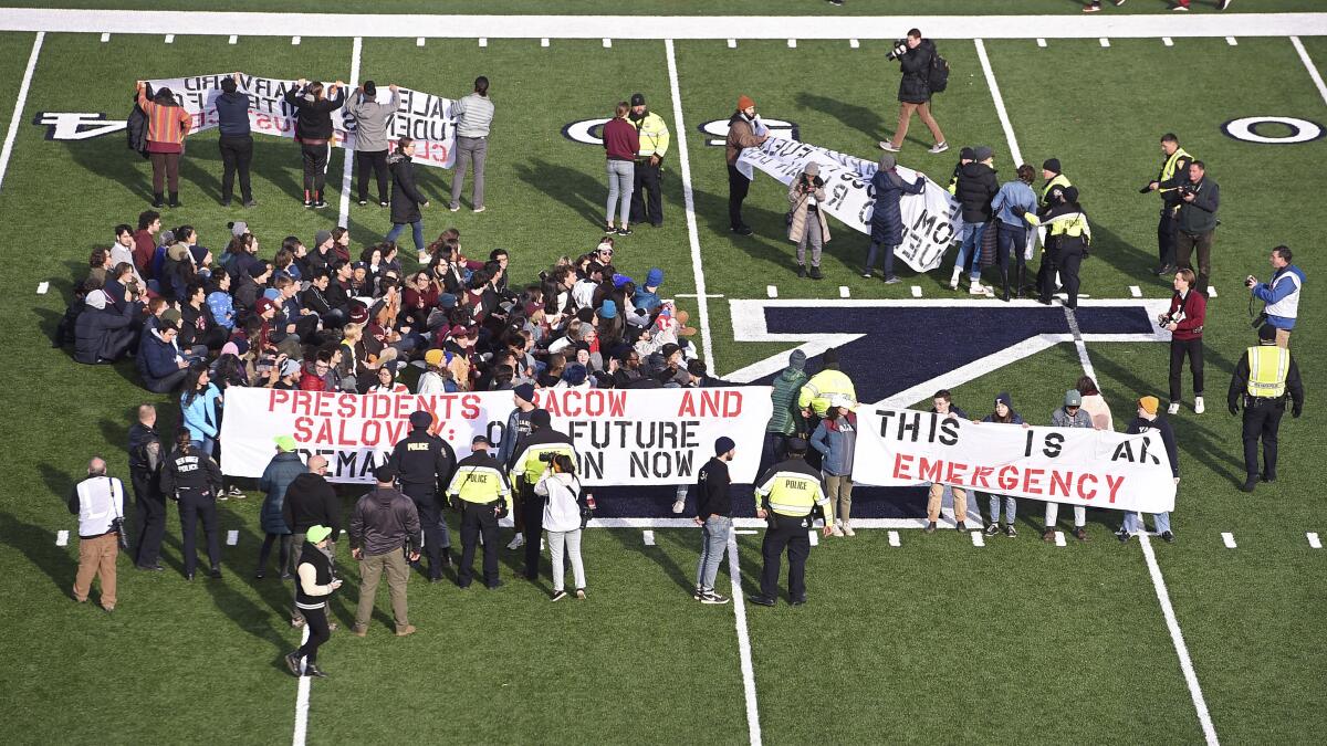 Protesters storm field at halftime of Harvard-Yale game - Los