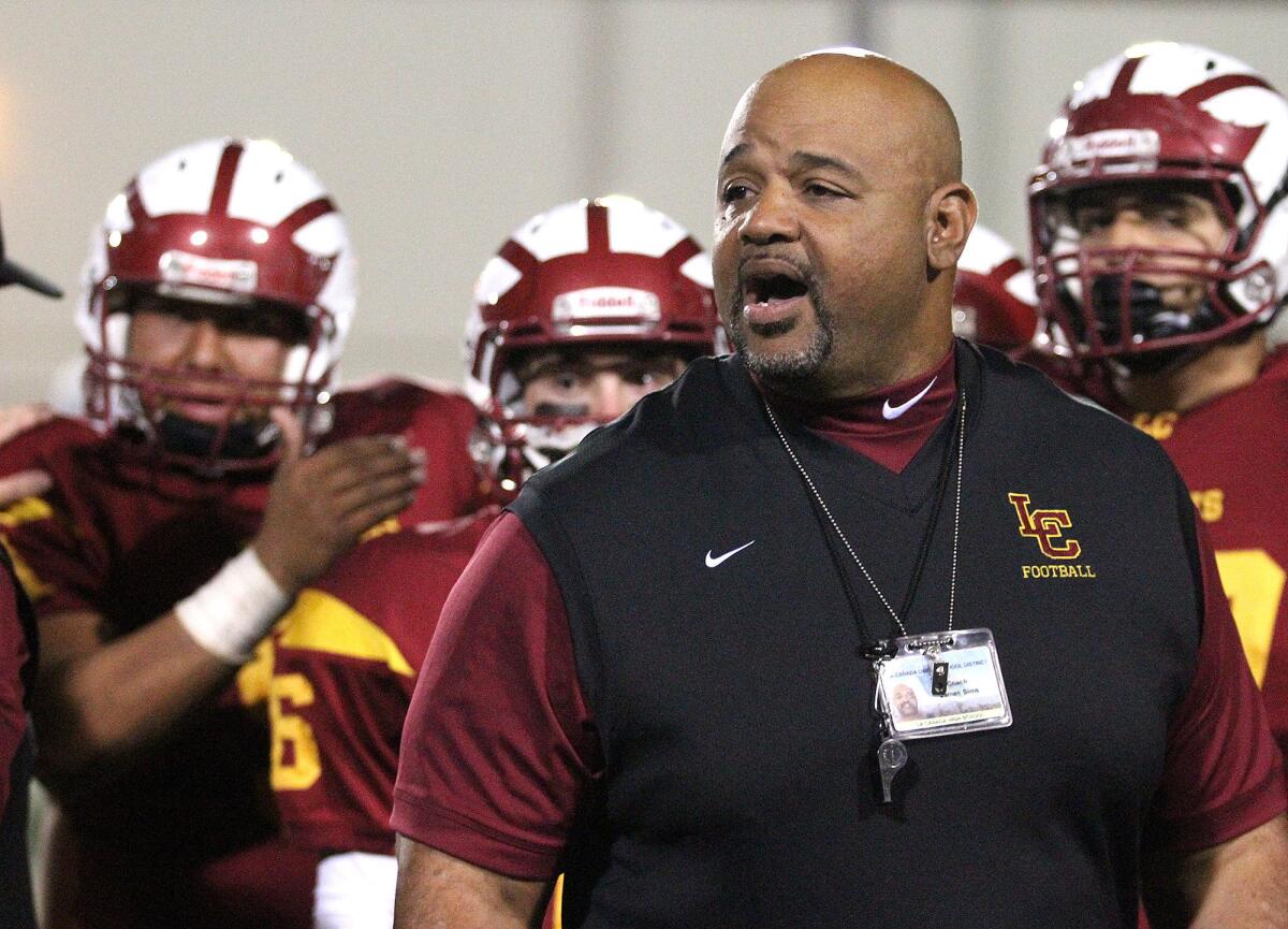 La Canada's coach James Sims during a timeout against Arroyo in a non-league football game at La Canada High School's 50th homecoming on Friday, October 4, 2013.