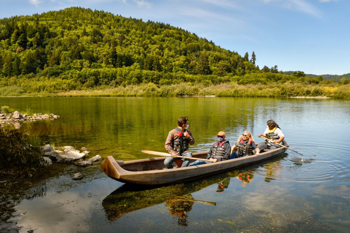 People paddle a canoe on the Klamath River.