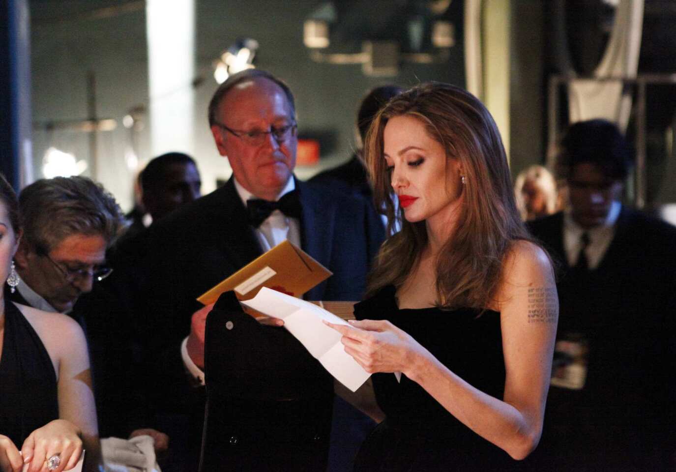 The star prepares backstage at the 2012 Academy Awards in Hollywood. Jolie presented the screenplay trophies.