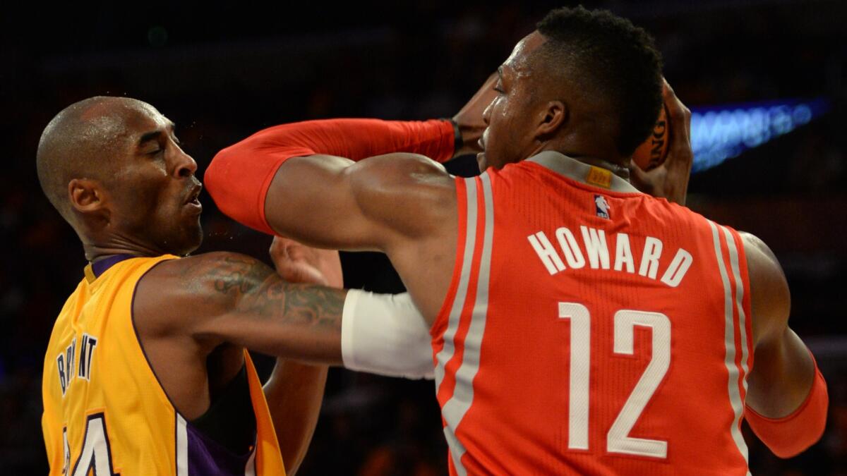 Lakers star Kobe Bryant, left, clashes with Houston Rockets forward Dwight Howard during the Lakers' 108-90 loss Tuesday.