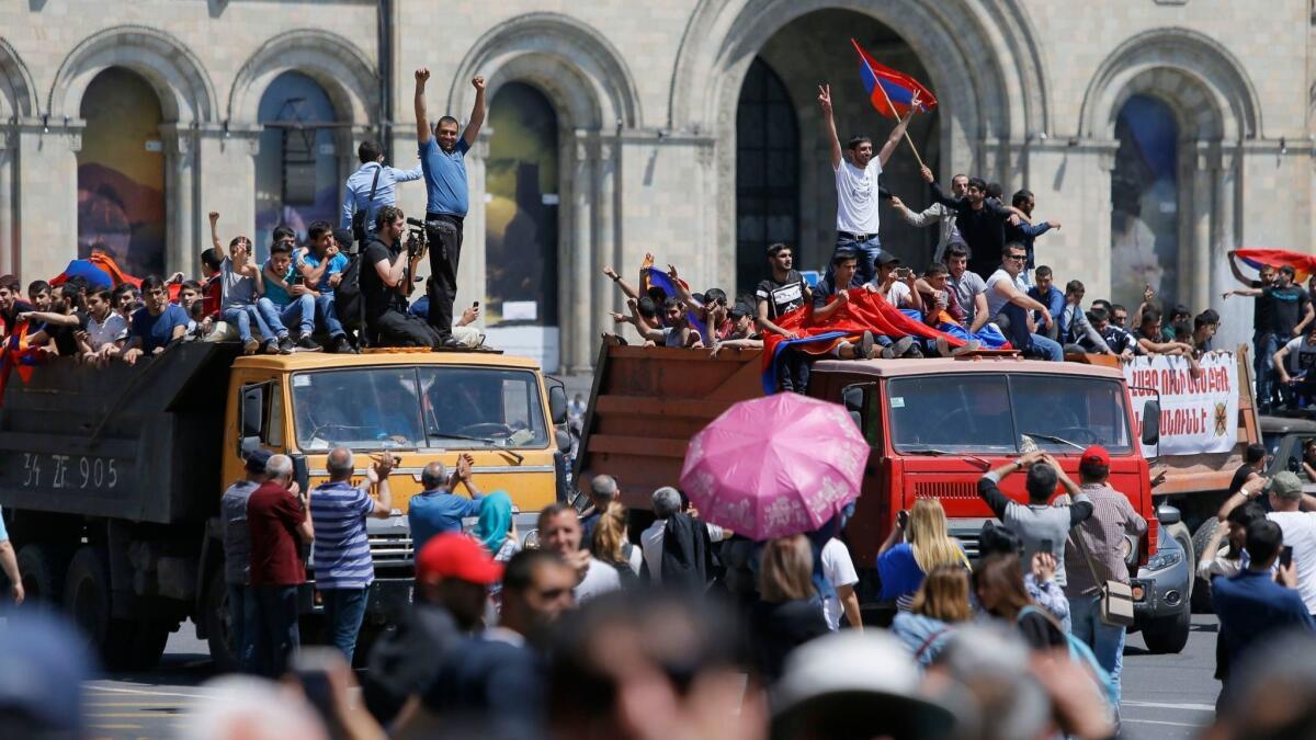 Armenian protestors ride on trucks as they block a street in Yerevan, Armenia, on May 2.