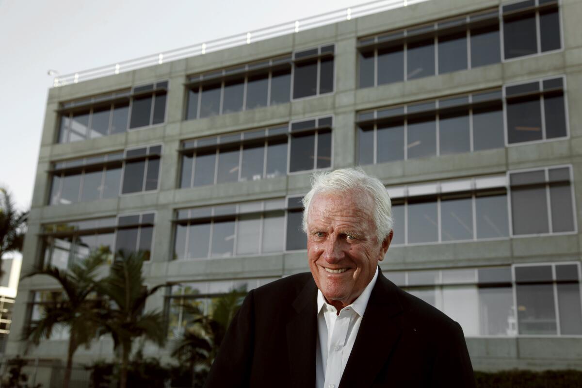 Robert F. Maguire III in front of a building