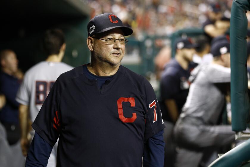 Cleveland Indians manager Terry Francona walks in the dugout.