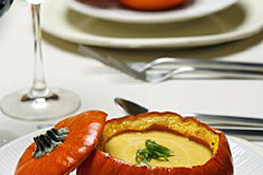 IMPRESS YOUR GUESTS: Serve spiced pumpkin soup with maple syrup inside roasted pumpkins. Total time: 2 hours Servings: 12 Note: From Noelle Carter. Grade B maple syrup is preferred for this recipe; it has a richer flavor and is not as highly filtered as Grade A. The mini pumpkins can be roasted several hours ahead. Place the roasted pumpkins in a 250-degree oven for 5 to 10 minutes to warm them before filling. 2 poblano chiles 4 tablespoons butter, divided 12 mini (12- to 16-ounce) pumpkins Fine sea salt Freshly ground black pepper 5 pounds pumpkin such as Sugar Pie or American Pie (2 small or 1 medium) 4 ounces apple wood-smoked bacon, about 3 thick slices, cut into 1/4 -inch dice 1 large onion, cut into medium dice 1/4 cup dry white wine 6 to 7 cups chicken broth, divided 1/2 teaspoon Hungarian paprika 1 teaspoon New Mexico chile powder 1/2 cup maple syrup, divided 1 1/2 cups heavy cream Tabasco sauce to taste 1 bunch green onions , green parts thinly sliced crosswise, the rest set aside for another use 1. Heat the oven to 425 degrees. 2. Roast the poblano chiles over high heat on a rack on your stove-top burner. When the skin is charred all over, place the peppers in a paper bag. Leave them for about 10 minutes, then remove and peel the skin -- do not rinse. Discard the stem and seeds, and chop the peppers coarsely. Set aside. 3. Prepare the pumpkins: In a small saucepan, melt 2 tablespoons butter over low heat. Remove from the heat and set aside. Cut the top quarter off of each of the 12 pumpkins, as if you are making jack-o'-lanterns, but make the hole wide enough for the pumpkin to work as a soup bowl. 4. With a spoon, clean out, then discard the seeds and pulp. Save the stemmed tops; these will work as "lids." Lightly brush the melted butter onto the inside of each pumpkin and the underside of each top. Lightly season the inside of each pumpkin and the underside of each top with salt and pepper. 5. Place the pumpkins cut-side up on a parchment-lined baking sheet. Place the pumpkin lids cut-side down on the same sheet, with the lids in the middle of the sheet (they'll cook quicker). You may need to do this in two batches. Bake for 25 to 30 minutes, just until the centers are slightly softened and the skins are golden. Do not overbake the pumpkins or they will not support the soup. Set aside. 6. Cut the 5 pounds of pumpkin, unpeeled, into about 1-inch pieces, discarding the seeds, pulp and stem. Set aside. 7. Place the bacon and remaining 2 tablespoons butter in a large, heavy-bottom stockpot over medium heat. Cook the bacon, stirring occasionally until it just begins to crisp, about 6 to 8 minutes. Add the onion, and continue cooking until the onion just begins to caramelize, an additional 12 to 15 minutes. Add the diced chiles, stirring to combine. Add the wine and scrape all the cooked bits from the bottom of the pan and cook until almost all of the wine is absorbed. Stir in the pumpkin, and then add 6 cups of the broth. Add 2 teaspoons salt, one-half teaspoon pepper, the paprika, chile powder and one-fourth cup maple syrup. Adjust the heat so the soup comes to a low but steady simmer. Cover and cook, stirring occasionally, until the pumpkin is very soft and tender, about 45 minutes to an hour. 8. Remove the soup from the heat and puree in a blender, food processor, or with an immersion blender. Place the soup back in the pot over low heat and stir in the cream. If the soup is too thick, add up to a cup of the reserved broth. Taste and adjust the seasoning with more of less of the remaining maple syrup, if needed, (depending on the sweetness of the pumpkins) and a few dashes of Tabasco. Remove the soup from heat. 9. Pour the soup into each of the small pumpkins, and garnish each serving with a little of the sliced green onion. Serve immediately. Each serving: 252 calories; 5 grams protein; 23 grams carbohydrates; 2 grams fiber; 17 grams fat; 10 grams saturated fat; 54 mg. cholesterol; 689 mg. sodium.