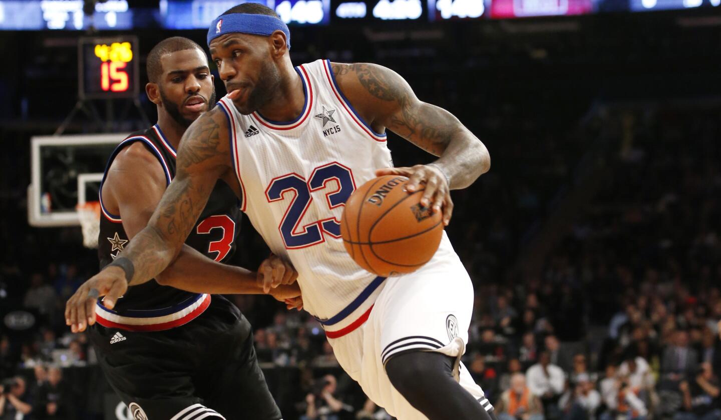 East forward LeBron James of the Cavaliers drives against West guard Chris Paul of the Clippers during the second half of the NBA All-Star game Sunday at Madison Square Garden.