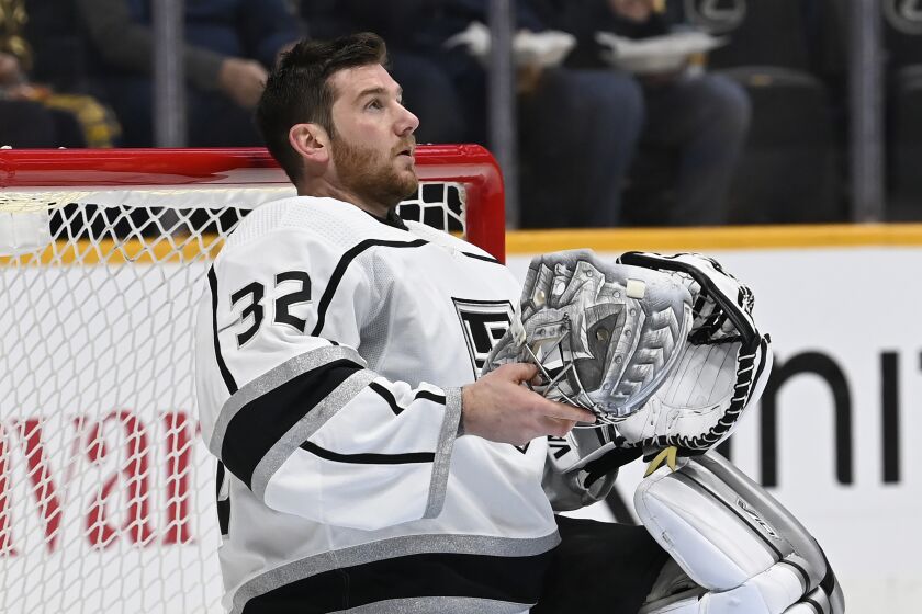 Los Angeles Kings goaltender Jonathan Quick (32) holds his mask during a timeout in the second period.