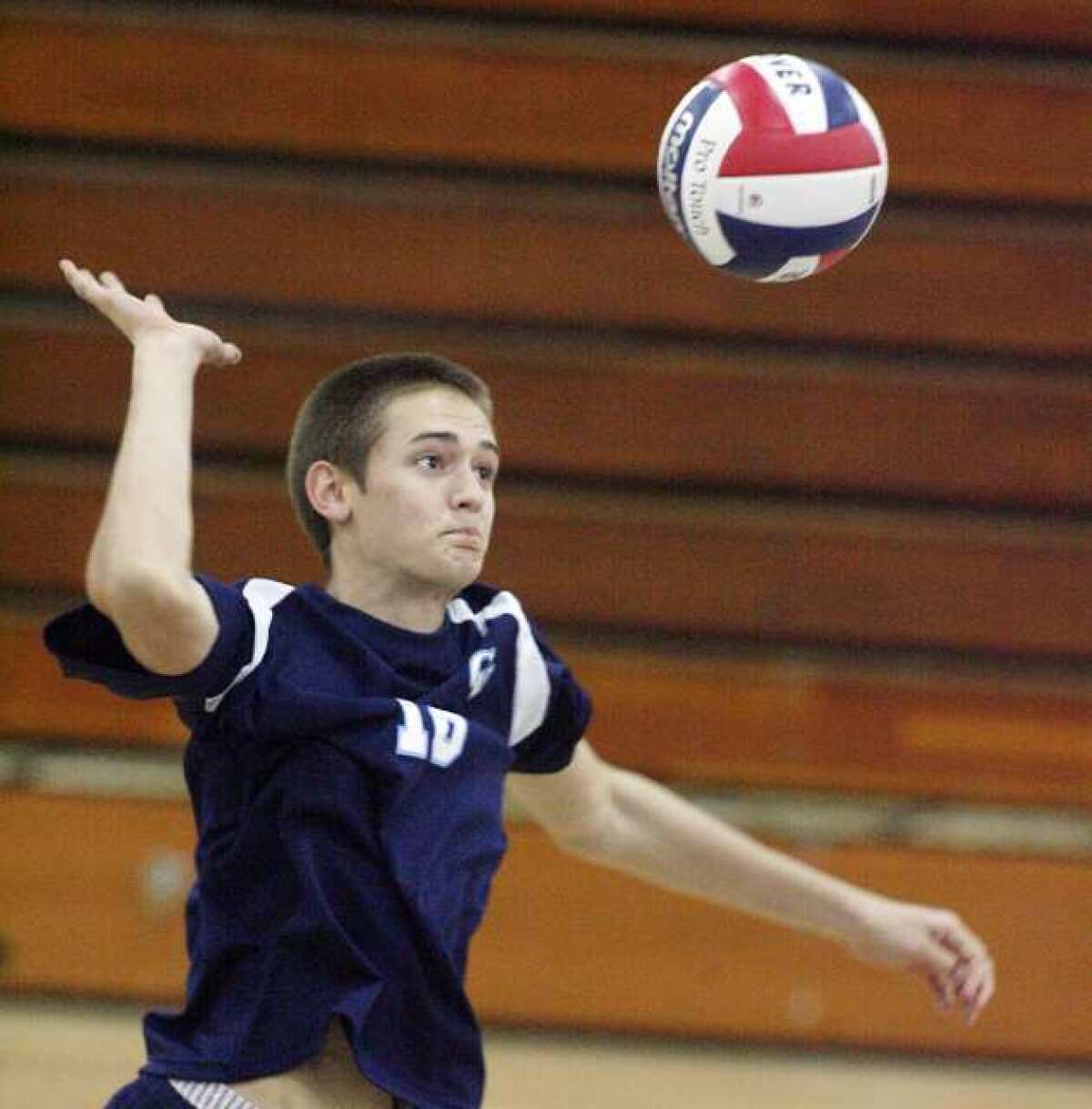 ARCHIVE PHOTO: Crescenta Valley's Freedom Tripp jumps for a kill attempt against Hoover in a Pacific League boys volleyball match.