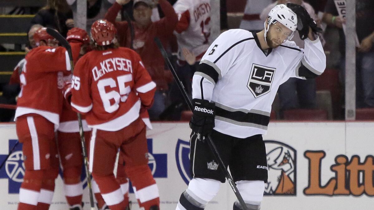 Kings defenseman Jake Muzzin skates away as the Detroit Red Wings celebrate a goal by Pavel Datsyuk during the first period of the Kings' 5-2 loss Friday.