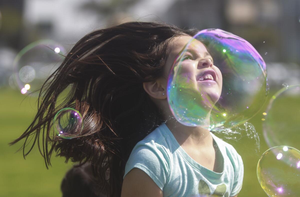 A child plays with bubbles.