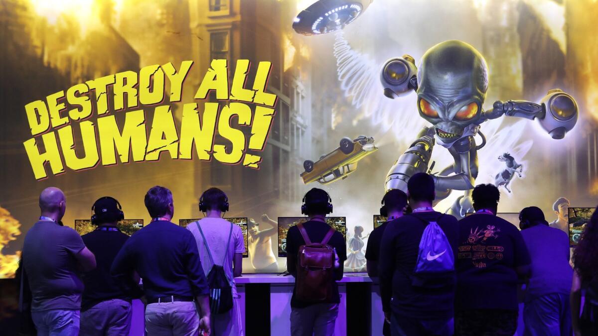 Attendees engage with “Destroy All Humans!” at the THQ Nordic booth during E3 at the Los Angeles Convention Center.