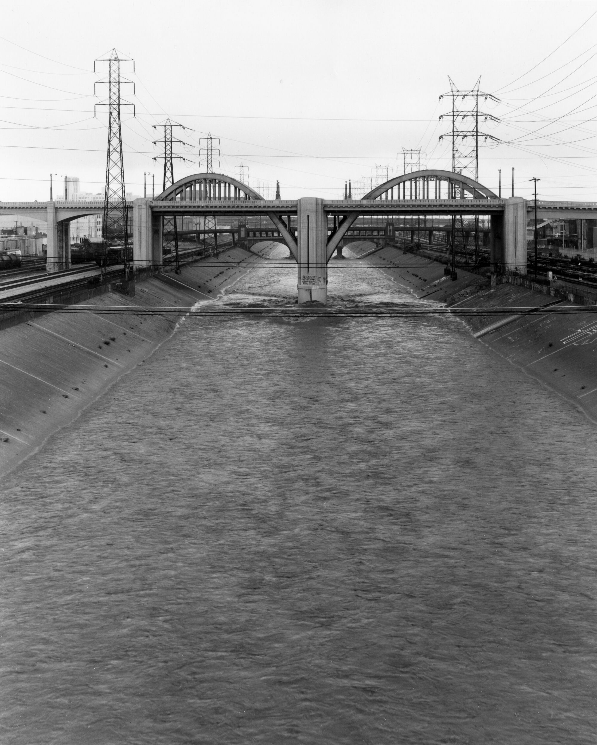 A black and white images shows the portion of the old 6th Street Viaduct running over the channelized L.A. River