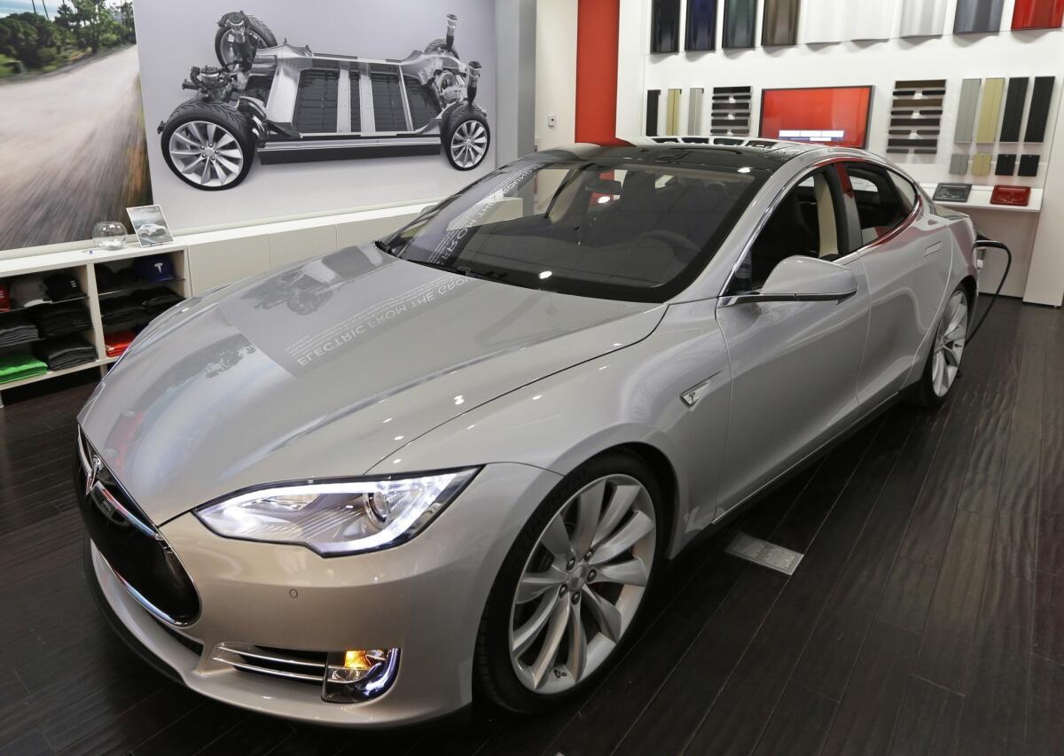 A new Tesla car is on display at a showroom inside the Kenwood Towne Centre in Cincinnati.