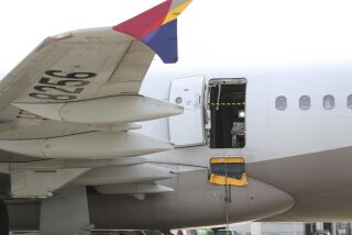 An Asiana Airlines plane is parked as one of the plane's doors suddenly opened at Daegu International Airport in Daegu, South Korea, Friday, May 26, 2023. A passenger opened a door on an Asiana Airlines flight that later landed safely at a South Korean airport Friday, airline and government officials said. (Yun Kwan-shick/Yonhap via AP)
