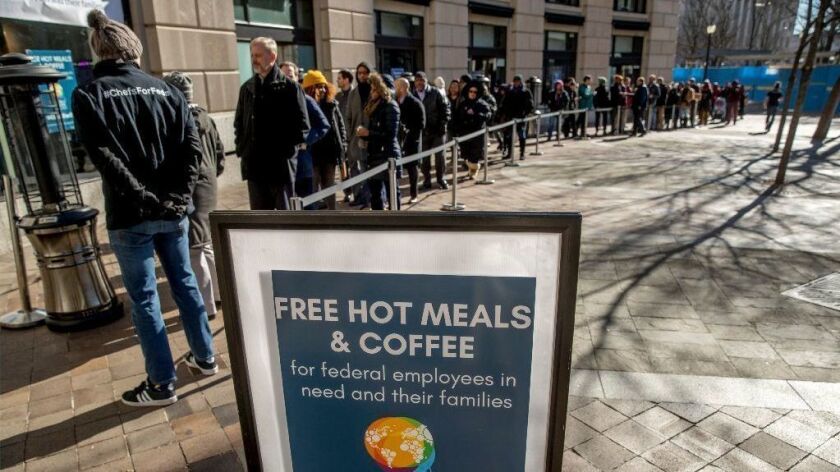 Furloughed workers wait in line to receive food and supplies from World Central Kitchen in Washington on Jan. 22, 2019.