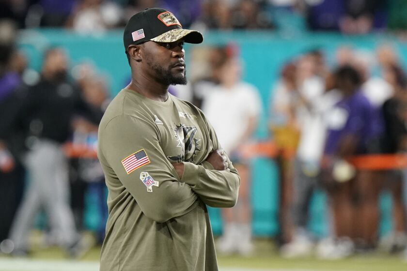 Miami Dolphins head coach Brian Flores stands on then field before an NFL football game against the Baltimore Ravens, Thursday, Nov. 11, 2021, in Miami Gardens, Fla. (AP Photo/Wilfredo Lee)