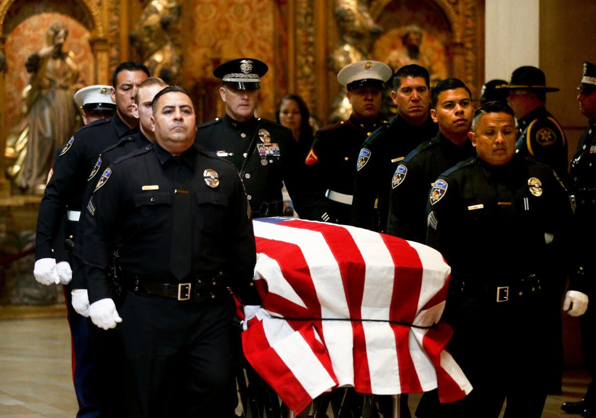 The honor guard escorts the coffin of slain Downey Police Officer Ricardo Galvez during funeral services at the Cathedral of Our Lady Of Angels in Los Angeles.