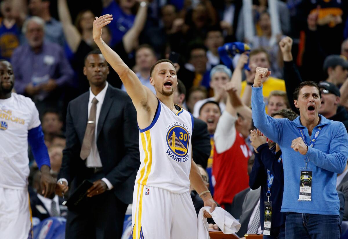 Stephen Curry celebrates from the bench during the Warriors' 121-106 victory over the Thunder on March 3.