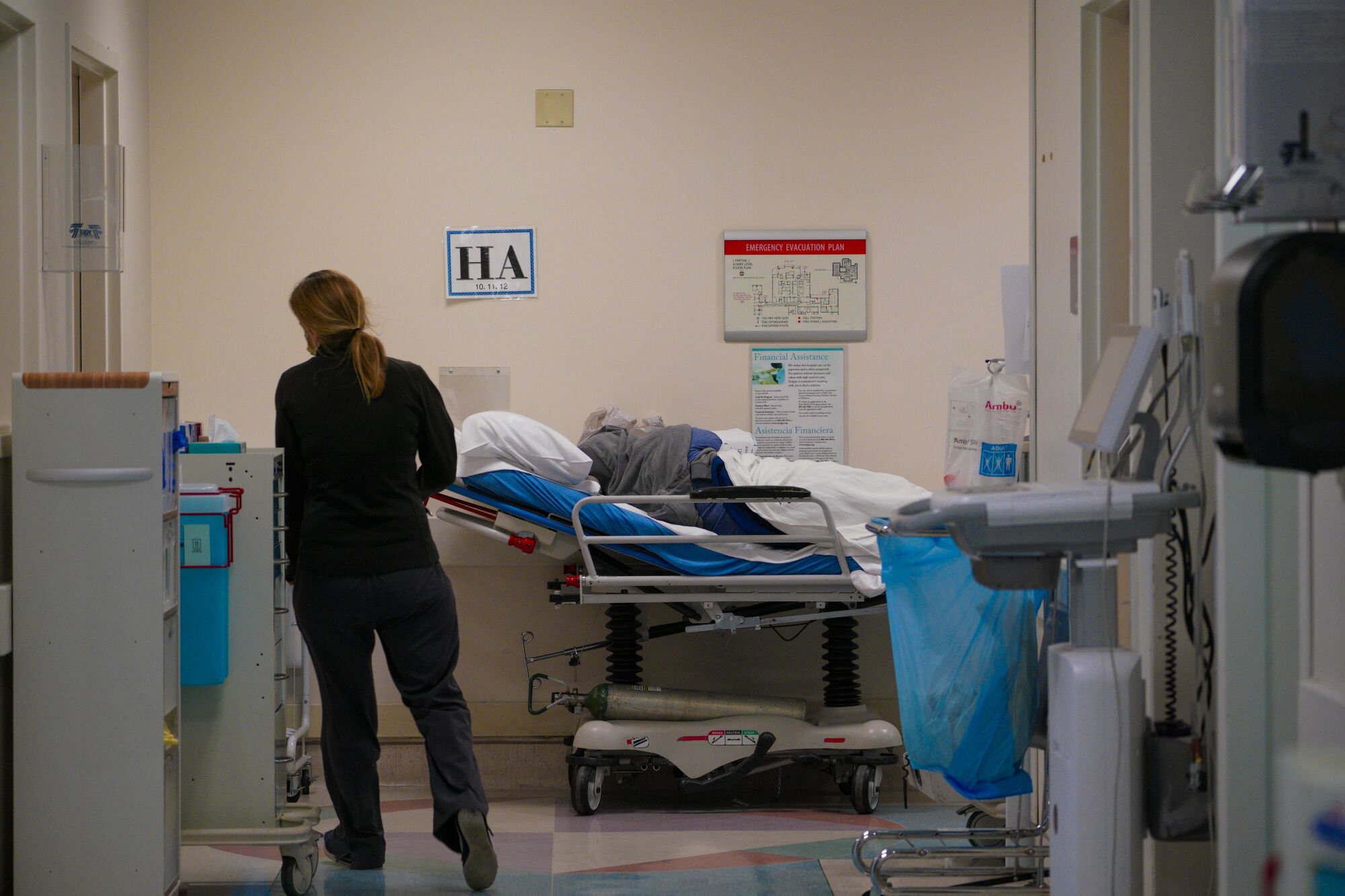 Emergency room personnel have had to use every available space to place patients, including the hallways.