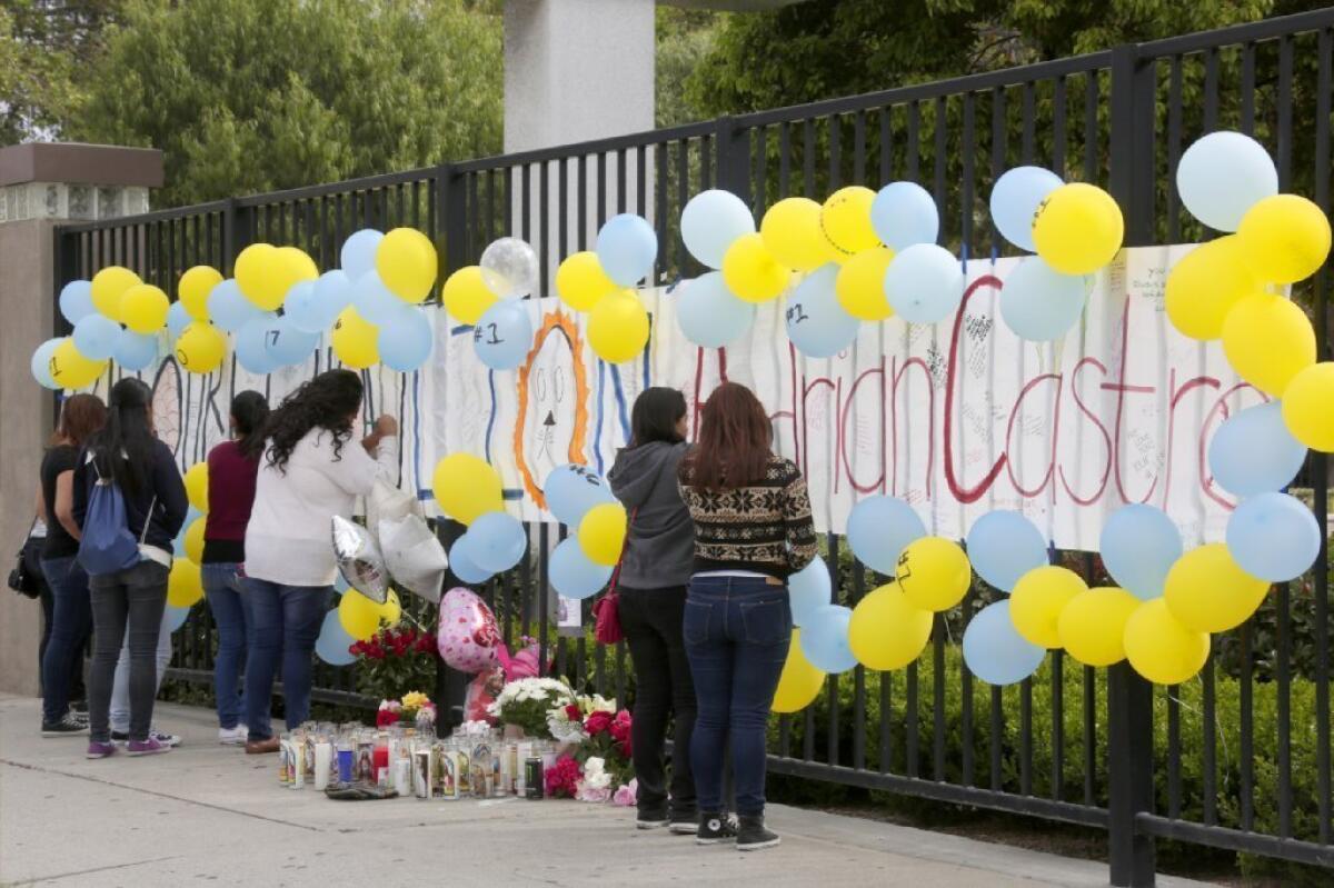 A group of students gather at El Monte High School on Saturday to create a memorial in honor of Adrian Castro, a student who was among those killed in a tour bus crash Thursday in Northern California.