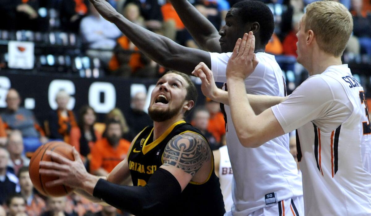 Arizona State forward Eric Jacobsen looks to score against the defense of Oregon State forwards Daniel Gomis, center, and Olaf Schaftenaar on Thursday night.