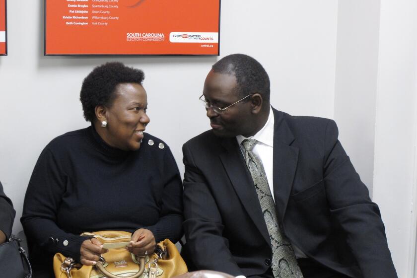 South Carolina state Sen. Clementa C. Pinckney, right, talks to a supporter during a break at a statehouse hearing in 2012. Pinckney was among nine killed by a gunman in their church in Charleston.