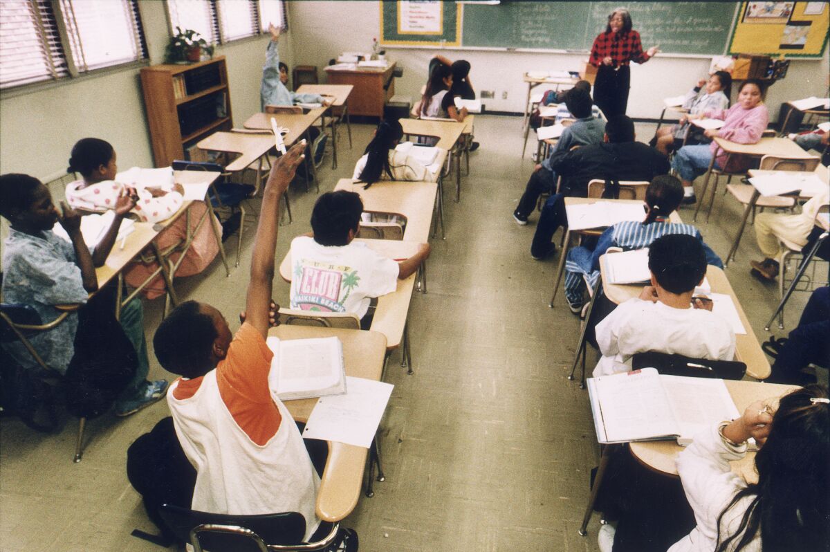Students sit at desks in a classroom