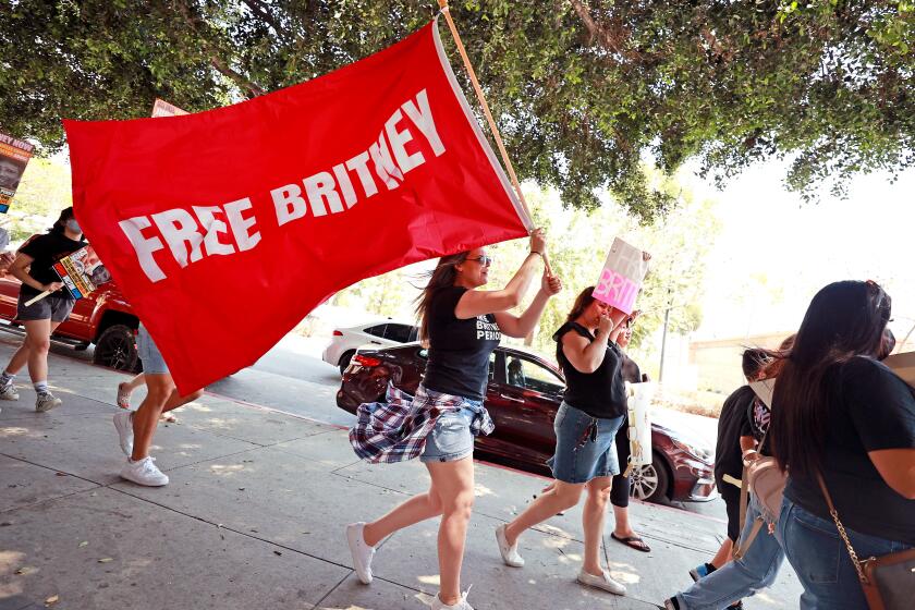 LOS ANGELES, CALIFORNIA - JULY 14: Protesters attend a #FreeBritney Rally at Stanley Mosk Courthouse on July 14, 2021 in Los Angeles, California. The group is calling for an end to the 13-year conservatorship lead by the pop star's father, Jamie Spears and Jodi Montgomery, who have control over her finances and business dealings. Planned co-conservator Bessemer Trust is petitioning the court to resign from its position after Britney Spears spoke out in court about the conservatorship. (Photo by Emma McIntyre/Getty Images)