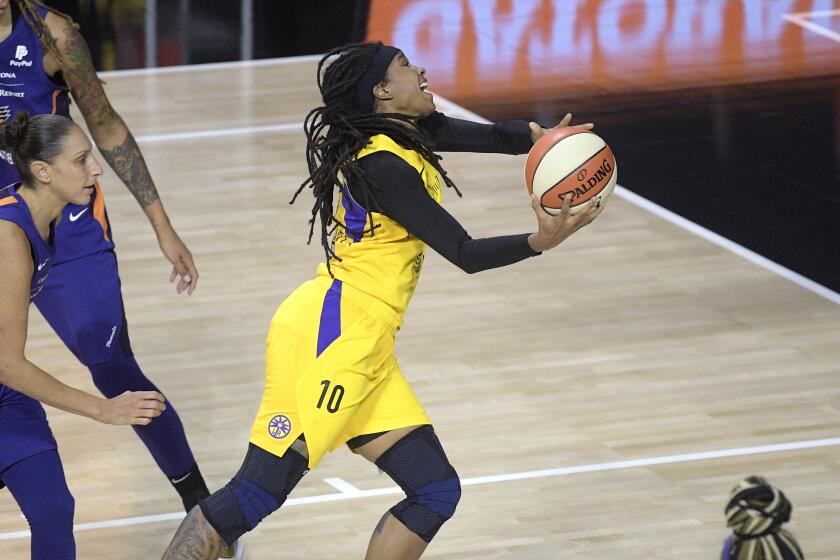 Los Angeles Sparks guard Tierra Ruffin-Pratt (10) goes up for a shot in front of Phoenix Mercury guard Diana Taurasi.