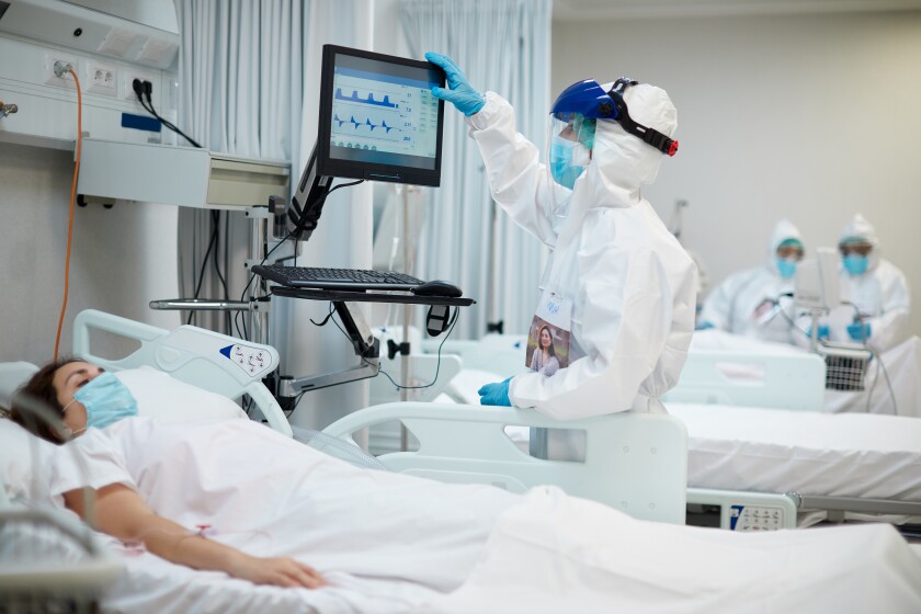 A nurse looks at the medical ventilator screen in the ICU of a COVID-19 ward.