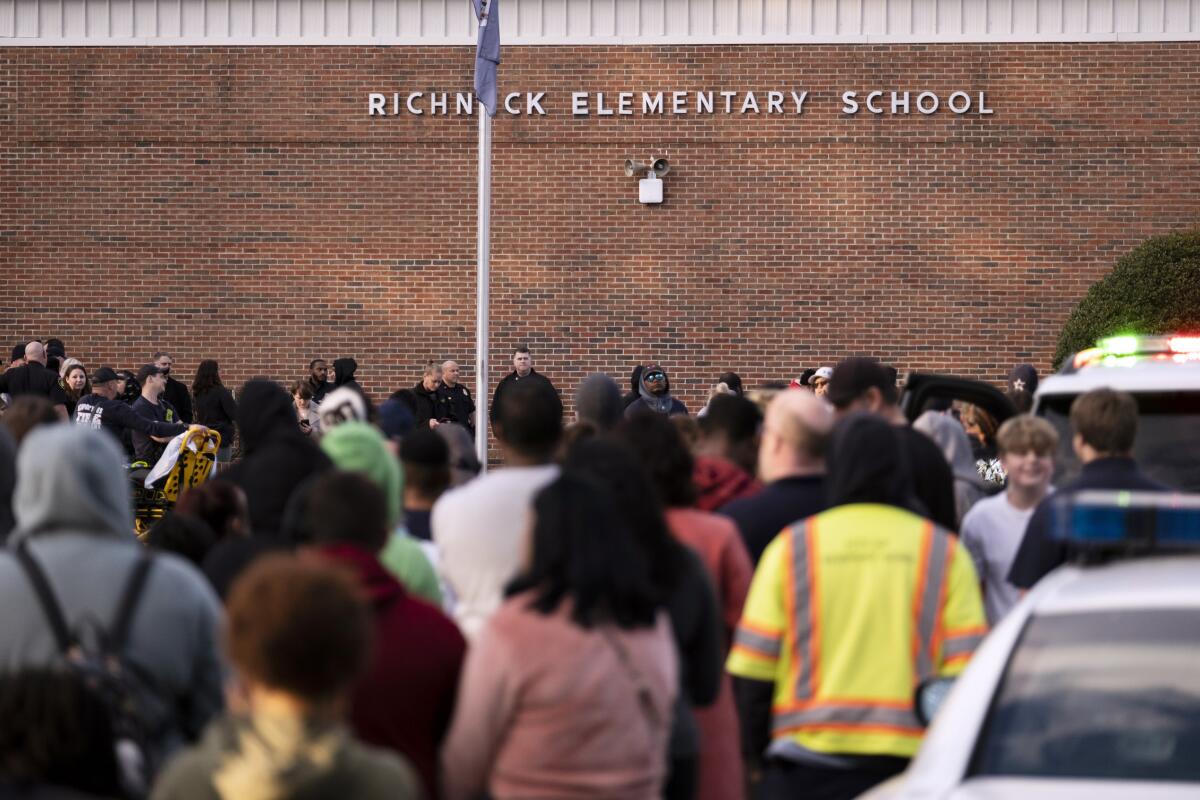 Students and police gather outside  Virginia elementary school after a shooting