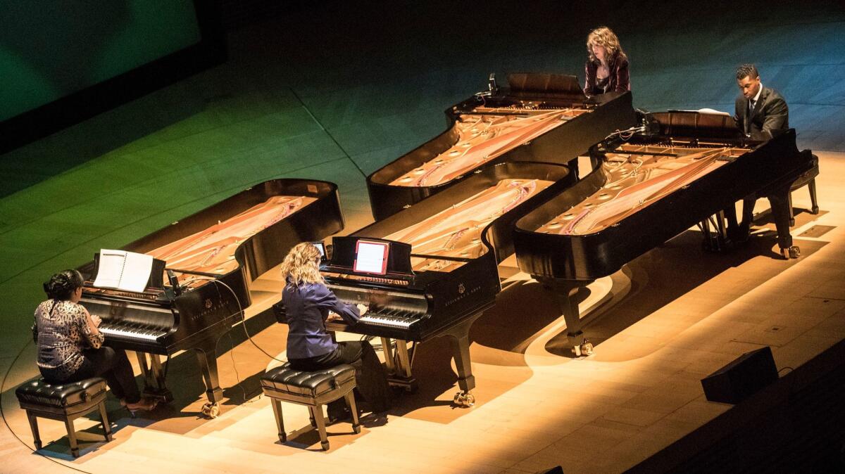 Pianists Michelle Cann, left, Joanne Pearce Martin, Vicky Ray and Dynasty Battles perform Julius Eastman's piece during the Green Umbrella concert Tuesday at Walt Disney Concert Hall.