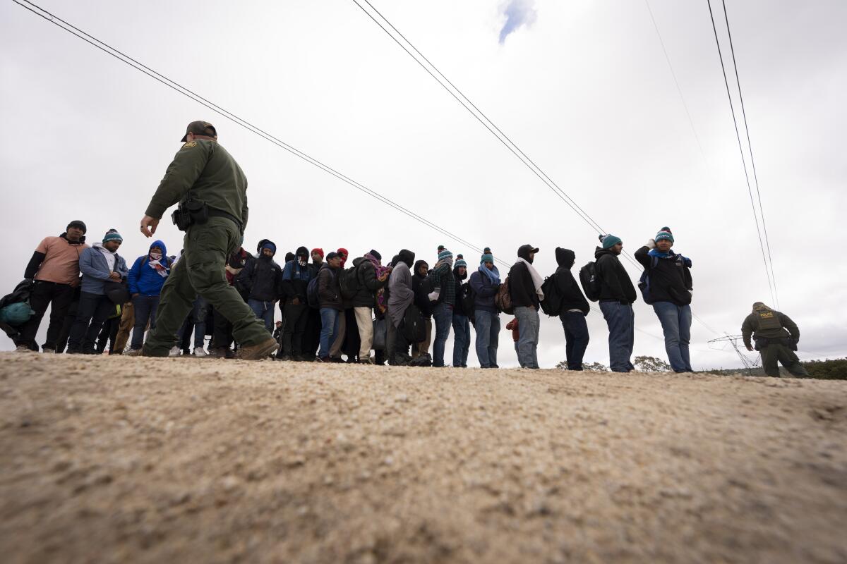 A line of men with border guards 