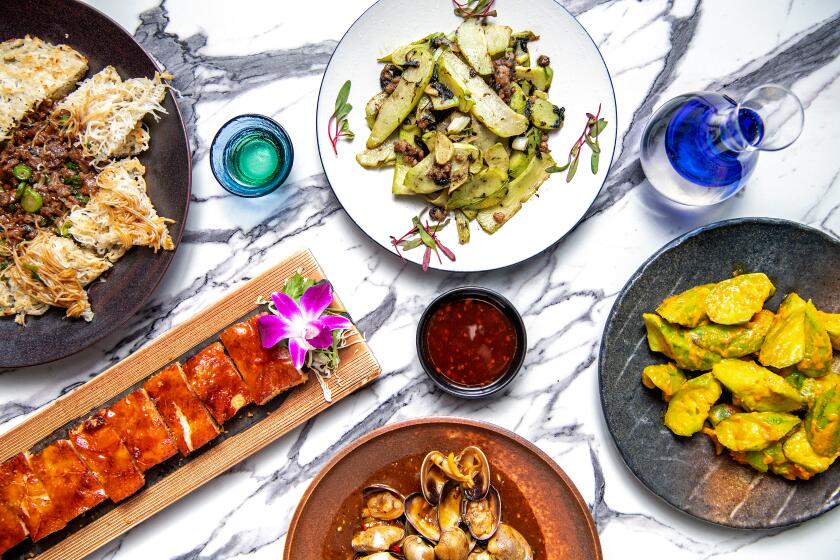 PASADENA, CA - JULY 12: clockwise from top: Sauteed chayote with minced pork, Golden Yolk Luffa, Spicy stir-fried clam, Crispy stuffed Chicken and Well-done Beef Vermicelli from Colette restaurant on Wednesday, July 12, 2023 in Pasadena, CA. (Mariah Tauger / Los Angeles Times)