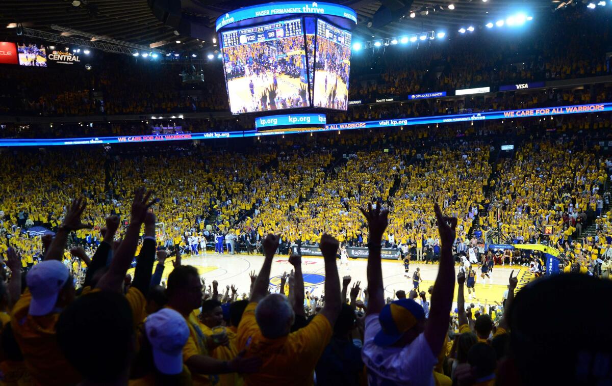 Warriors fans celebrate victory in Game 1 against the Cavaliers at Oracle Arena.
