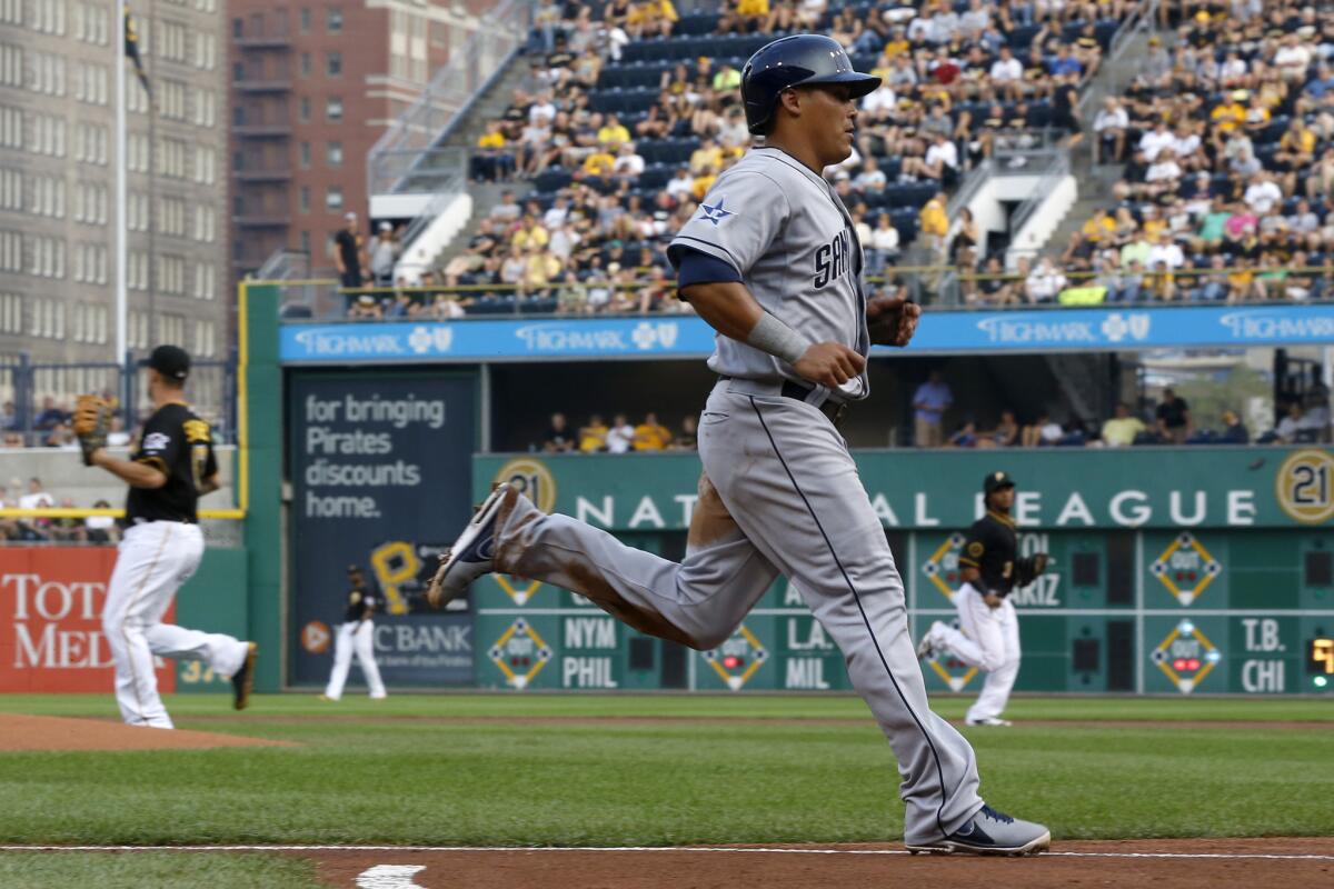 San Diego Padres' Everth Cabrera, foreground, scores during a game in August.