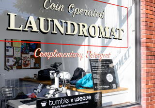 A humanoid robot named Isaac folds laundry at Sea Breeze Cleaners in San Francisco.