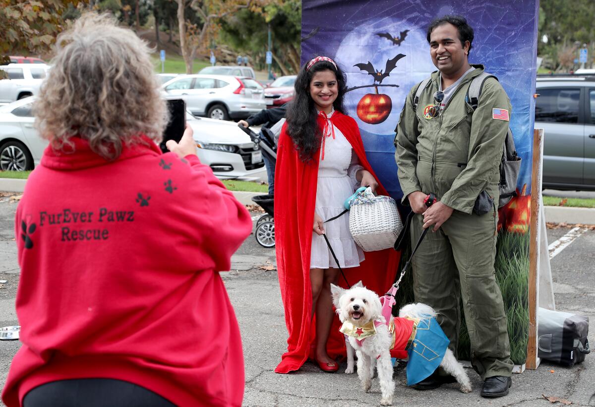 Shon Bangale, right, and Vasuda Trehan, both of Irvine, smile for a picture with their dogs Evee and Nymeria.