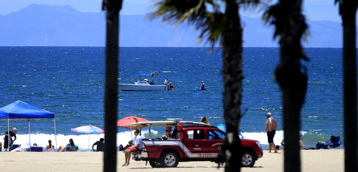 Lifeguards closed access to water off the coast of Huntington Beach Friday after a shark exhibited "aggressive behavior" and bumped a surfer.