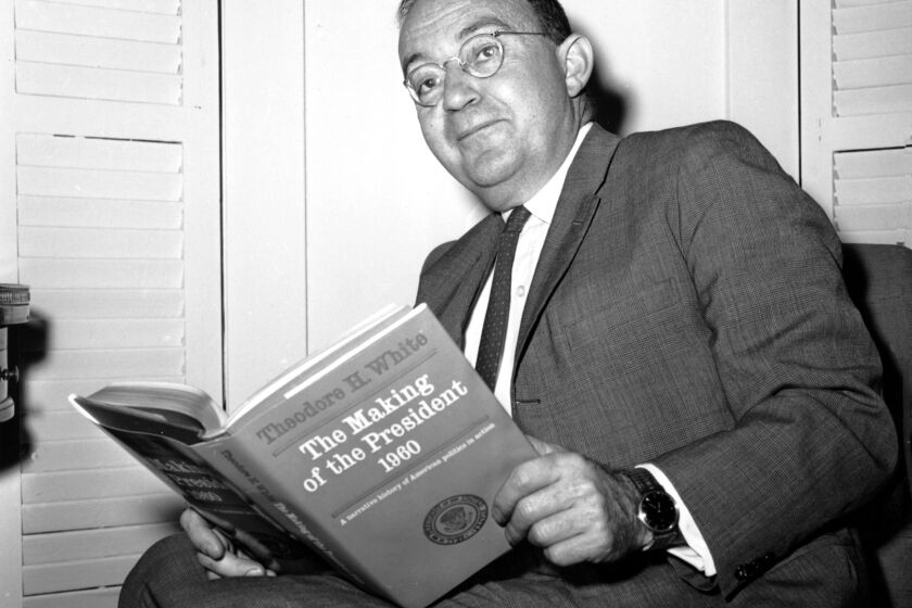 **FILE**Author Theodore H. White poses in his New York City apartment with the book that won him the Pulitzer Prize on May 7, 1962. White won for his book "The Making of a President, 1960." (AP Photo) ORG XMIT: NYET170