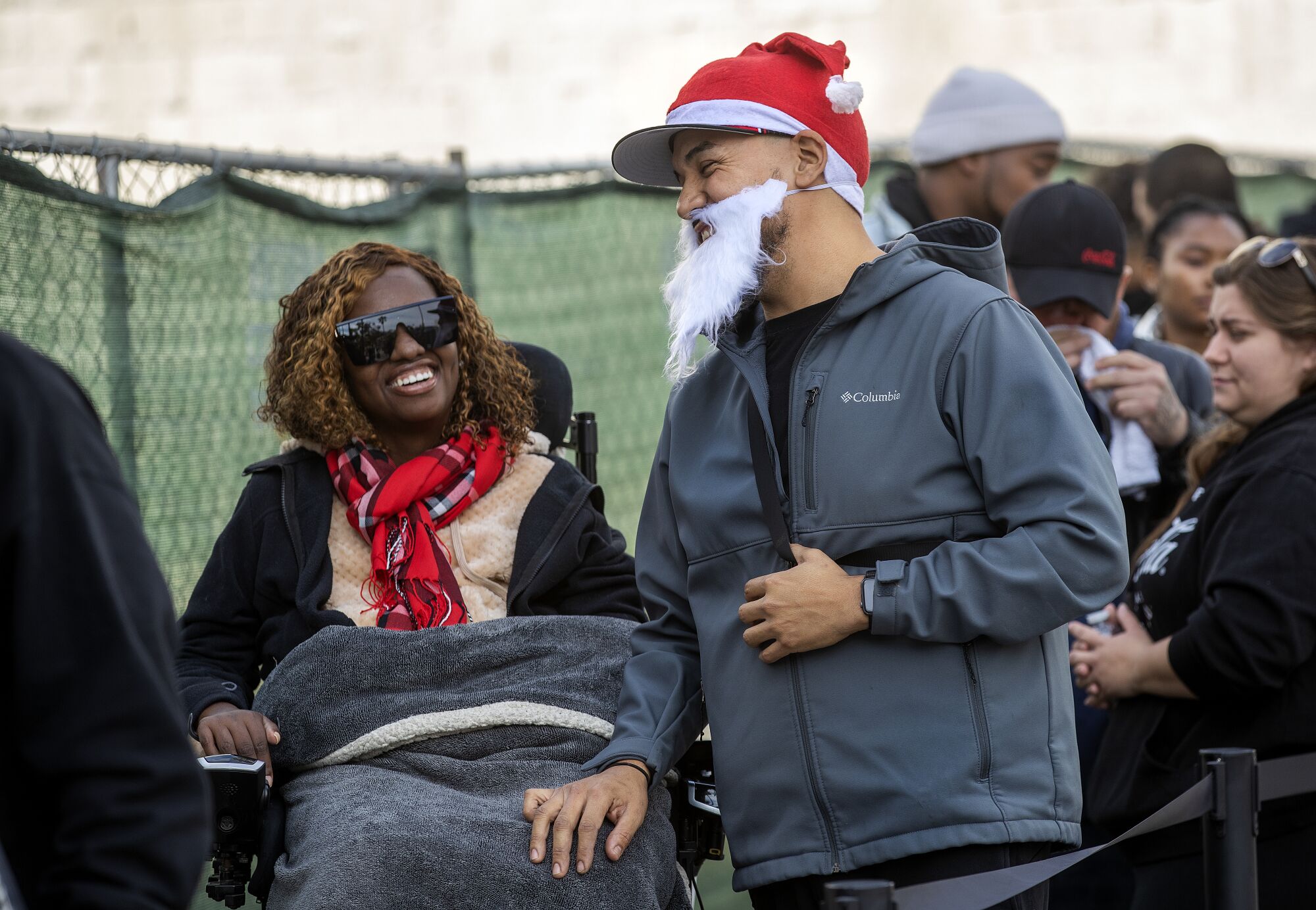 Emanuel Orozco, 38, and his wife Florida, wait in line with others for a prize money give-a-way at a T Mobile store 