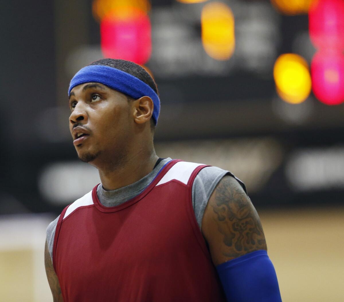 Carmelo Anthony walks onto the court for a practice Tuesday at the Knicks' training camp at the U.S. Military Academy in West Point, N.Y.
