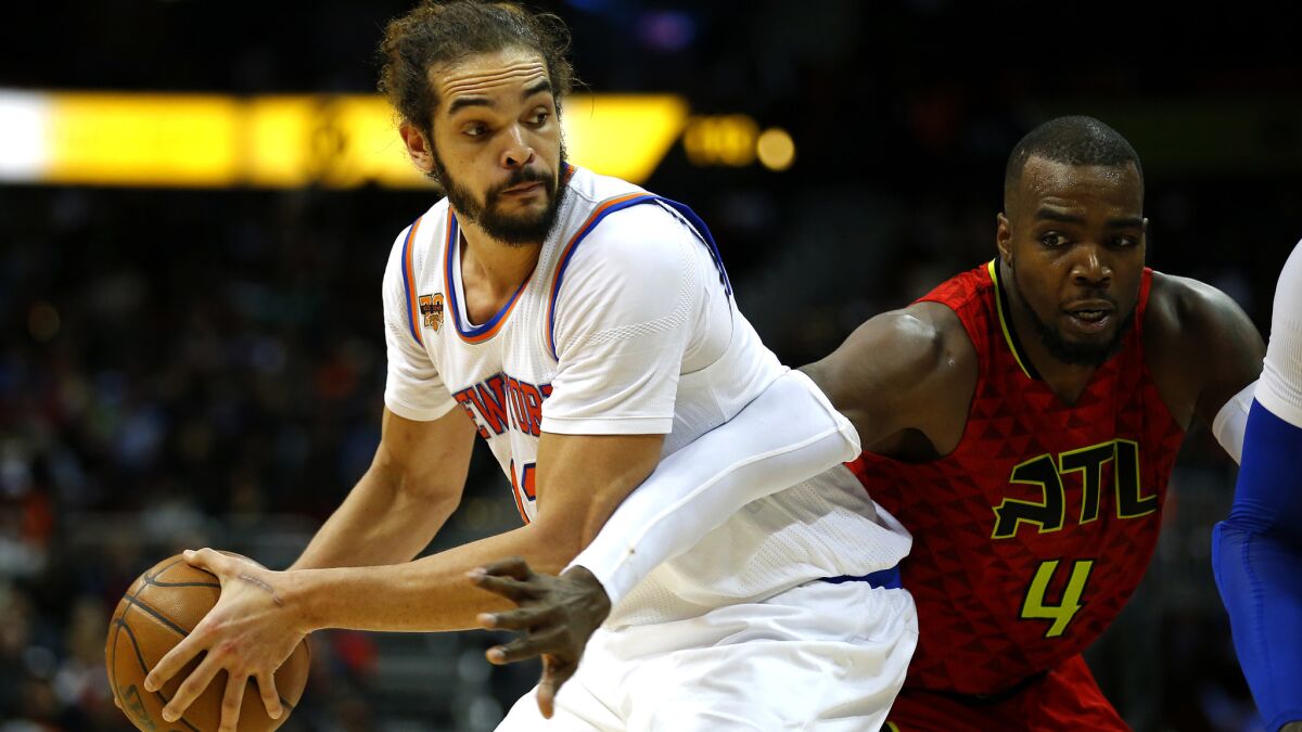 Knicks center Joakim Noah looks to pass while guarded by Hawks forward Paul Millsap a game on Jan. 29, 2017, in Atlanta.n the game in the fourth overtime 142-139. (AP Photo/Todd Kirkland)