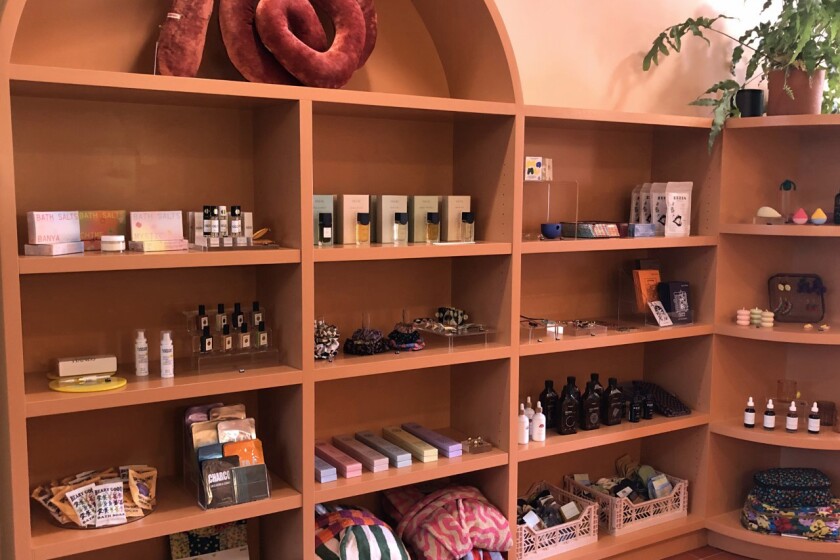 Shelves are lined with perfume, oils, candles and other gifts.